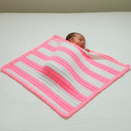 Newborn with full pink crochet blanket visible
